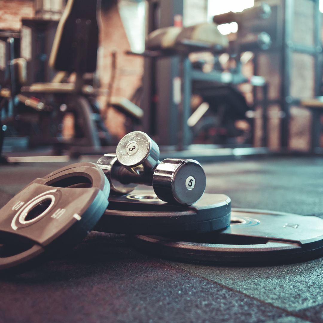 dumbells and weights laying on the floor