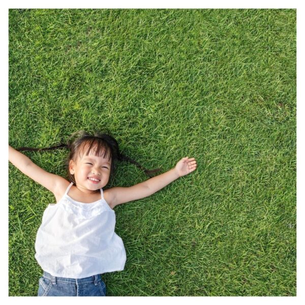 girl playing on artificial grass