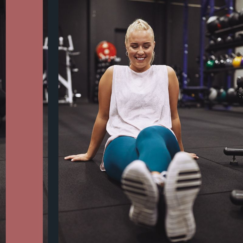woman sitting on the gym floor